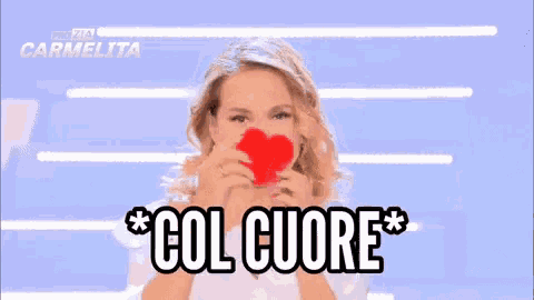 a woman is holding a red heart in her mouth and says col cuore in black letters