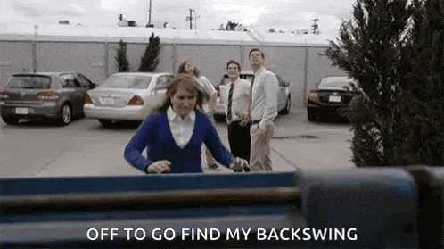 a group of people are standing in a parking lot and one of them is holding a skateboard .