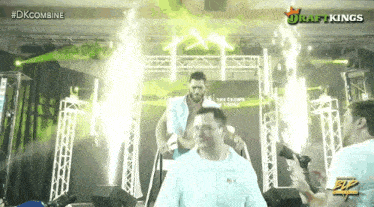 a group of men are walking through a stage with the words draftkings on the bottom