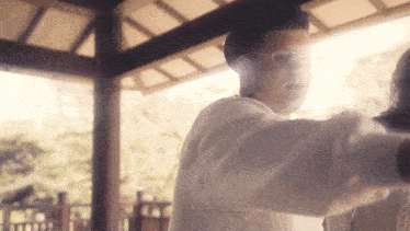 a man wearing glasses and a hat is standing in front of a woman