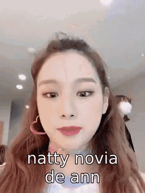 a close up of a woman 's face with the words `` natty novia de ann '' written on it .