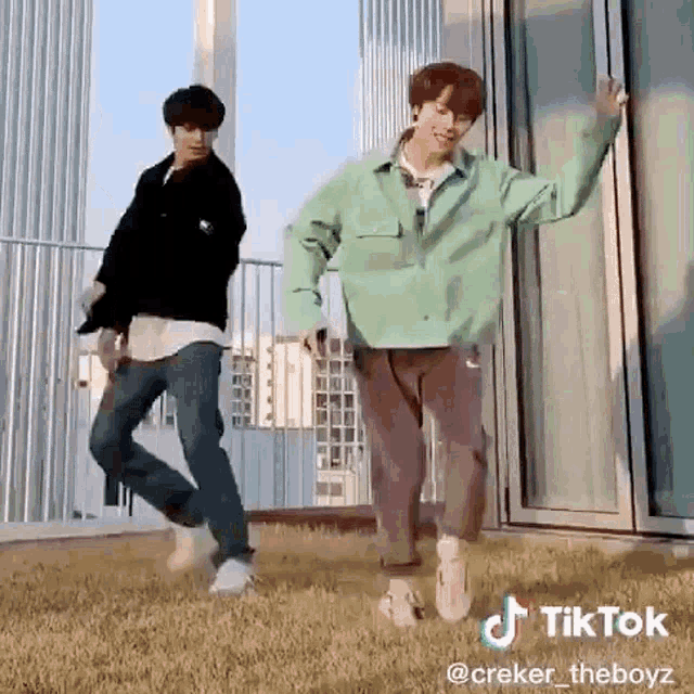 two young men are dancing on a rooftop .