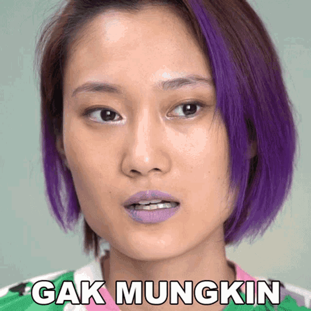 a woman with purple hair has the words " cak mungkin " above her face