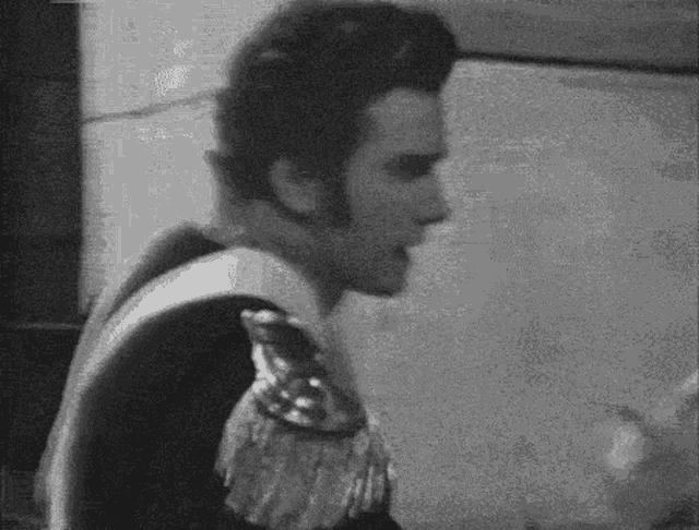 a black and white photo of a man in a costume