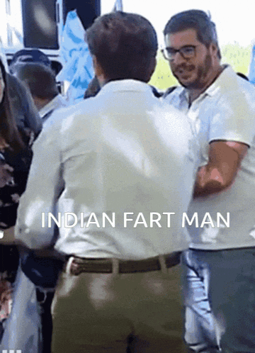 a man in a white shirt is standing next to another man with the words indian fart man written below him