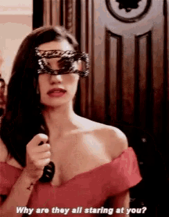 a woman wearing a mask and sunglasses is asking why are they all staring at you .