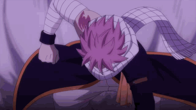 a person with pink hair and a scarf around their neck is laying down