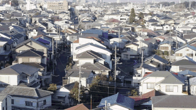 an aerial view of a residential area with lots of houses and roofs