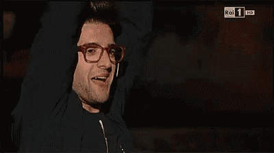 a man wearing glasses and ear buds is on a tv screen that says rai 1 hd