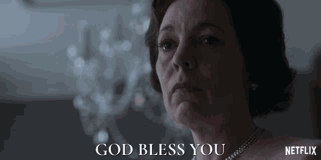 a close up of a woman 's face with the words god bless you above her