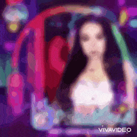 a woman is sitting in a chair with a rainbow in the background and the words vivavideo on the bottom .