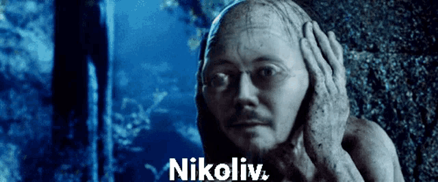 a statue of a man with the word nikoliv written below it