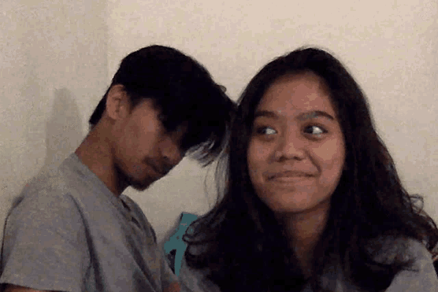 a man and a woman are looking at each other