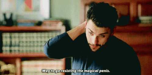 a man in a blue shirt is holding his head and says way to go resisting the magical penis