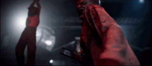 a man in a red coat is holding a cell phone in his hand