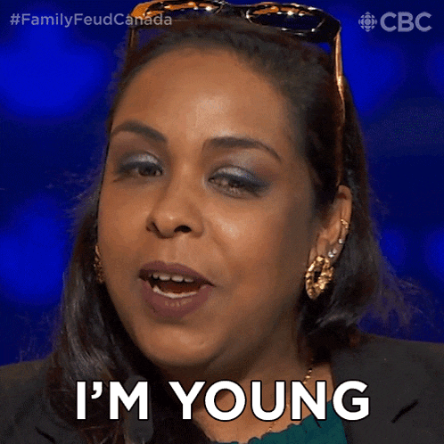 a woman says i 'm young while wearing sunglasses and earrings