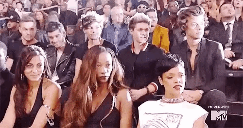 a group of people are sitting in a stadium watching a performance .