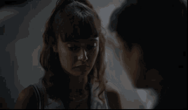 a man and a woman are looking at each other