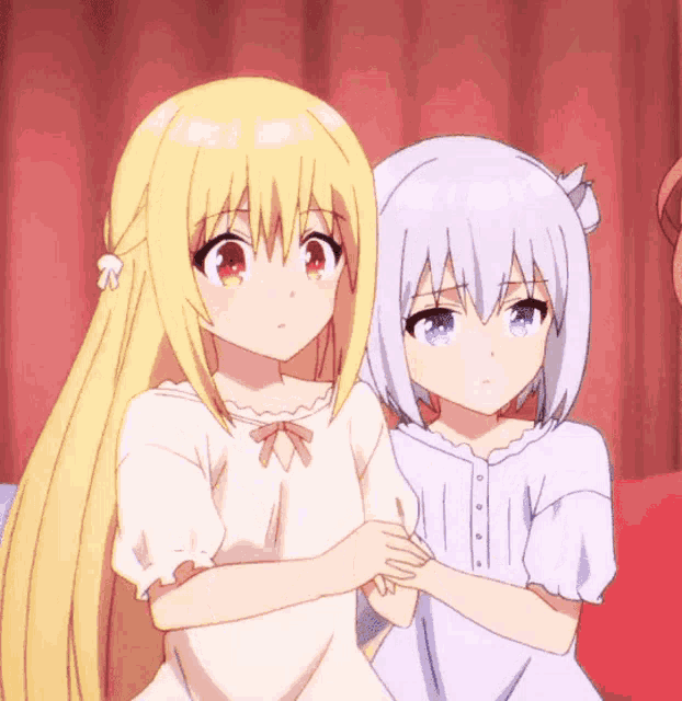 two anime girls sitting next to each other on a red couch