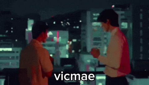two men are standing next to each other and the word vicmae is on the bottom