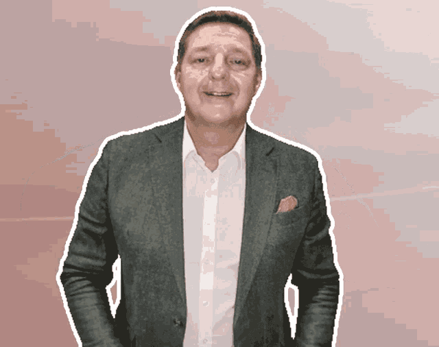 a man in a suit and a white shirt is smiling