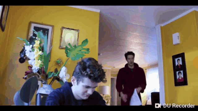 a du recorder screen shows two men in a room