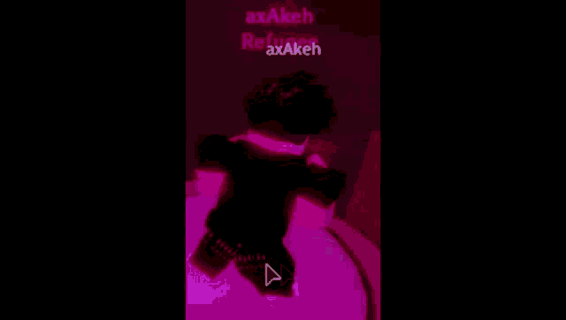a person is standing in a dark room with a pink light behind them and the name axakeh is visible
