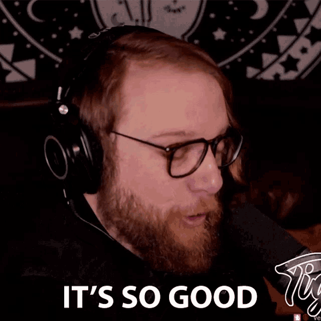 a bearded man wearing headphones and glasses says it 's so good