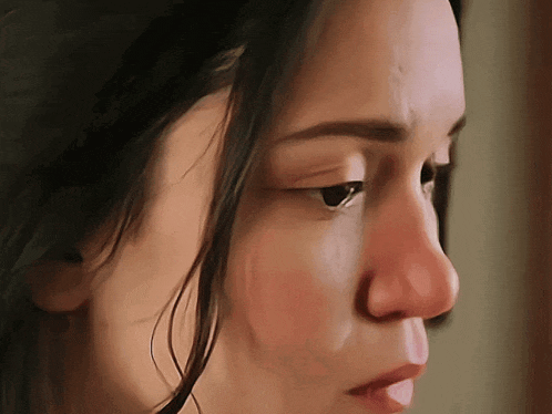 a close up of a woman 's face shows a red nose