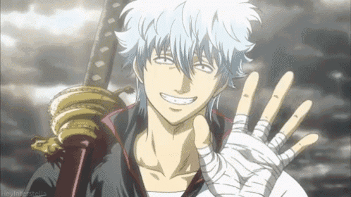 a man in a bandaged hand is holding a sword and smiling .