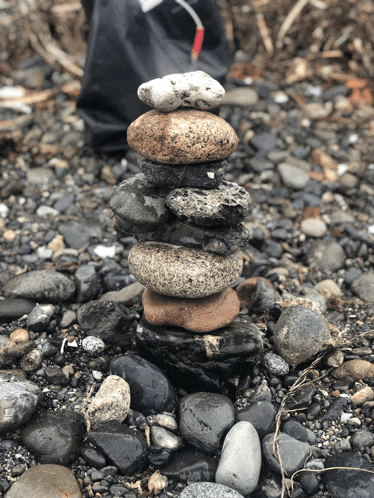 a pile of rocks stacked on top of each other on a rocky beach