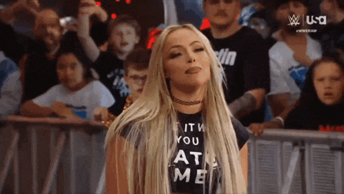 a woman is wearing a black shirt that says `` it 's you at me '' .