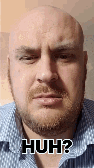 a bald man with a beard is making a funny face with the words huh behind him
