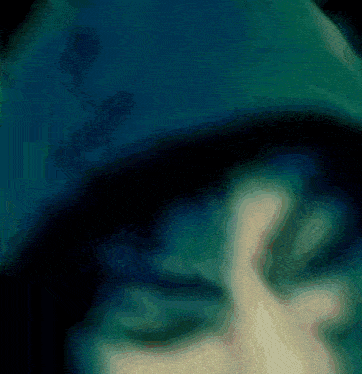 a blurry picture of a person 's face with a dark background