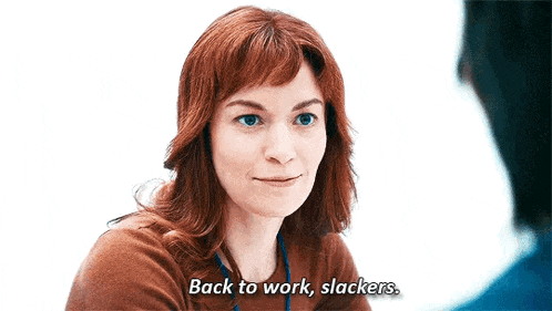 a woman with red hair is smiling and saying back to work slacker .