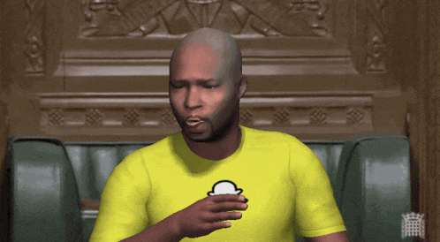 a bald man in a yellow shirt with a white hat on it