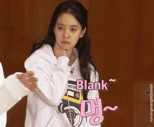 a woman in a white hoodie is standing next to a man in a white sweatshirt and says blank .