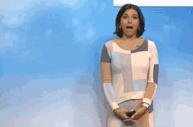 a woman with a surprised look on her face stands in front of a blue sky