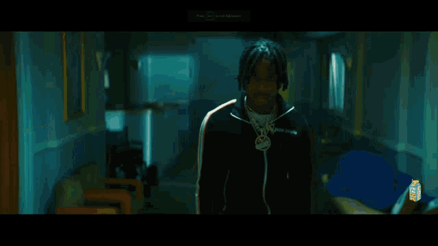 a man is standing in a hallway with a light shining on him