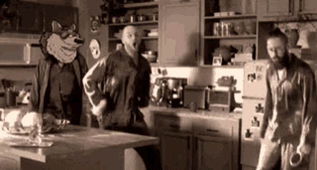 a group of men in pajamas are standing in a kitchen .