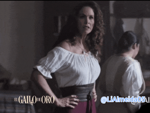 a woman in a white off the shoulder top is standing in front of a sign that says el gallo de oro