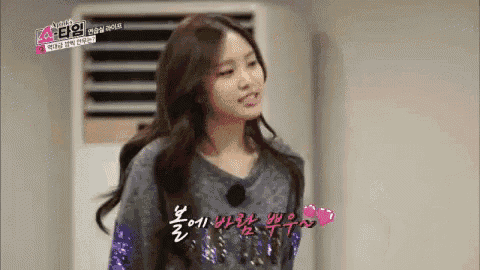a girl is standing in front of an air conditioner wearing a sequined sweater .