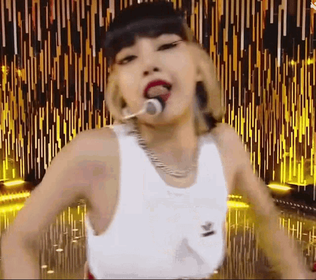 a woman is singing into a microphone on a stage .
