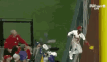 a baseball player is flying through the air near a yellow pole