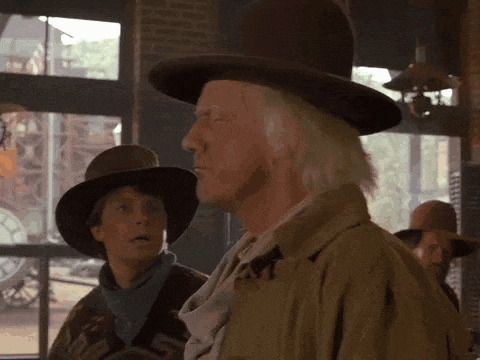 a man in a cowboy hat is standing next to a woman
