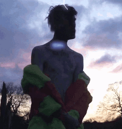 a silhouette of a shirtless man with a tattoo on his chest that says " i love you "