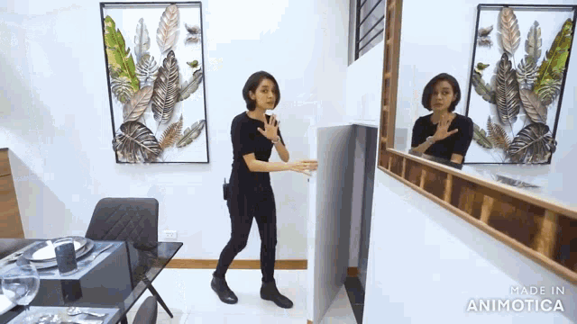 a woman standing in front of a mirror with the words made in animatica on the bottom right