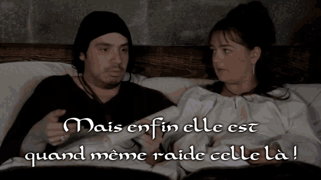a man and a woman are laying on a bed with the words mais enfin elle est quand meme raide celle la on the bottom