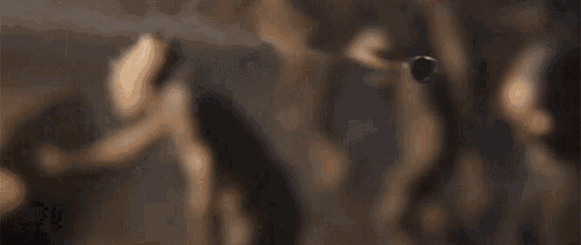 a blurred image of a group of zombies walking in a line