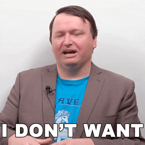a man in a suit and a blue shirt with a unicorn on it says i don 't want